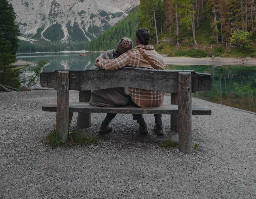 Retired couple sitting together watching the sunset over a lake